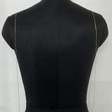 Black dress on a mannequin against a white background
